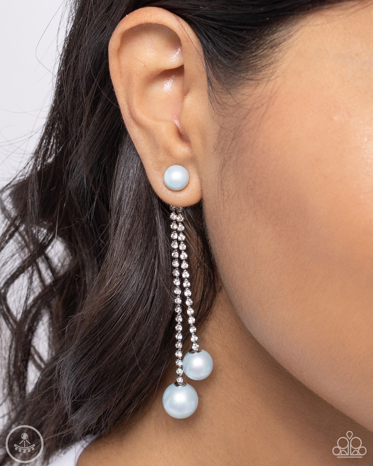 Give Us A PEARL! Blue Jacket Earring - Paparazzi Accessories  A solitaire light blue pearl attaches to a double-sided post designed to fasten behind the ear. Dotted in dainty white rhinestones, a duo of shimmery silver box chains swings from the bottom of the solitaire pearl fitting with additional light blue pearls peeking out behind the ear for a refining finish. Earring attaches to a standard post fitting.  Sold as one pair of post earrings.  P5PO-BLXX-180XX