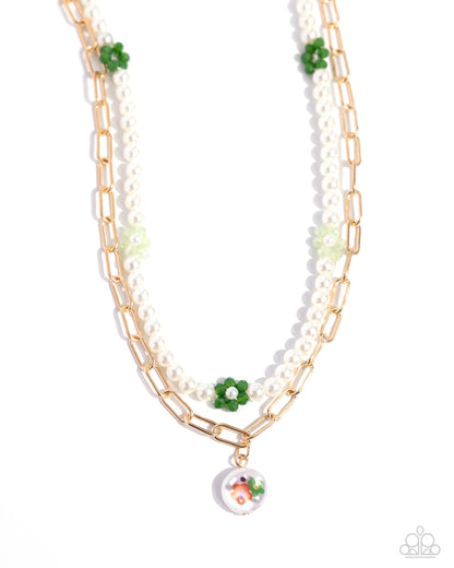 Painted Pageantry Green Necklace - Paparazzi Accessories Infused along an invisible string, glossy white pearls, haphazardly interrupted by pearl-centered green and light green flowers, loop around the neckline for a refined statement. Gold paperclip chain links layer below the pearly strand, leading the eye to a solitaire baroque pearl painted in multicolored floral detailing, for a spring-inspired spot of color and whimsy. Includes one pair of matching earrings. P2WH-GRXX-406XX