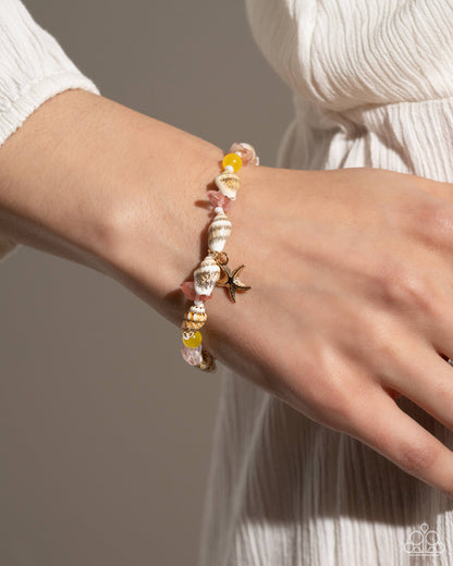 SAND-sational Statement Multi Bracelet - Paparazzi Accessories  Infused along an invisible string, a collection of white seashells, pearly white seed beads, and pink and yellow stones coalesce around the wrist. A gold starfish pendant dangles from the wrist for a beachy finish. Features an adjustable clasp closure.  Sold as one individual bracelet.  P9SE-MTXX-217XI