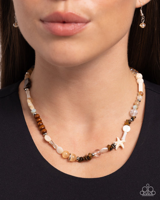 Beachy Beginner Brown Necklace - Paparazzi Accessories Infused along an invisible string, a collection of silver, clear, wooden, white stone, tiger's eye, UV-splashed, and brown cat's eye beads cascade below the neckline. White shells and white starfish charms are added to the display for a chic coastal finish. Features an adjustable clasp closure. As the stone elements in this piece are natural, some color variation is normal. Includes one pair of matching earrings. P2SE-BNXX-263XX