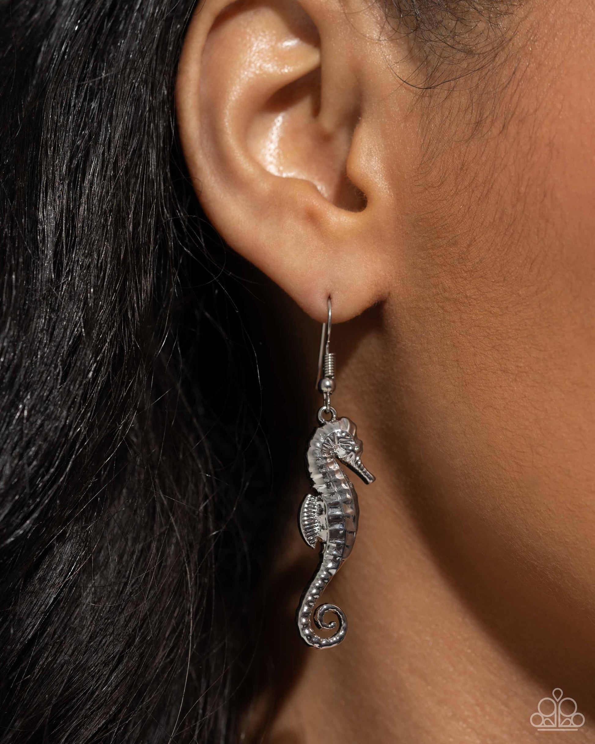 Seahorse Sheen Silver Earring - Paparazzi Accessories  A tactile detailed oversized silver seahorse cascades below the ear for a monochromatic, maritime display. Earring attaches to a standard fishhook fitting.  Sold as one pair of earrings.  P5SE-SVXX-199XR