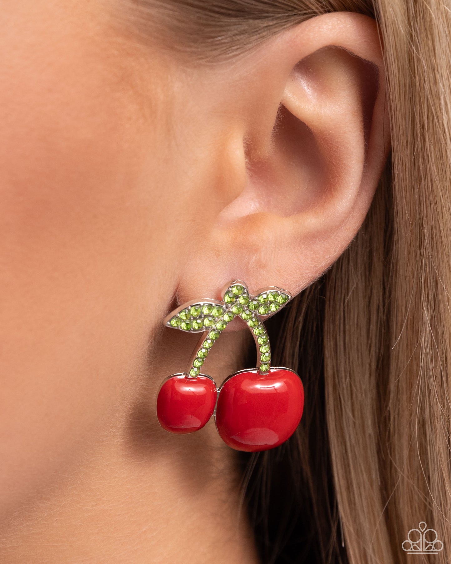 Charming Cherries Red Post Earring - Paparazzi Accessories  Embellished in light green rhinestones, silver stems featuring a vibrant duo of red cherries in varying sizes hang below the ear for a fantastic fruity display. Earring attaches to a standard post fitting.  Sold as one pair of post earrings.  SKU: P5PO-RDXX-064XX