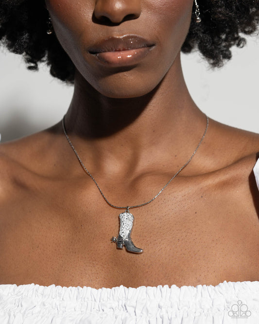 Cowboy Confidence White Boot Necklace - Paparazzi Accessories  Gliding along an abstract silver chain, a white pearl-painted silver cowboy boot with decorative-like stitching and a silver spur creates a western-inspired statement below the neckline. Features an adjustable clasp closure.  Sold as one individual necklace. Includes one pair of matching earrings.  P2SE-WTXX-320XV