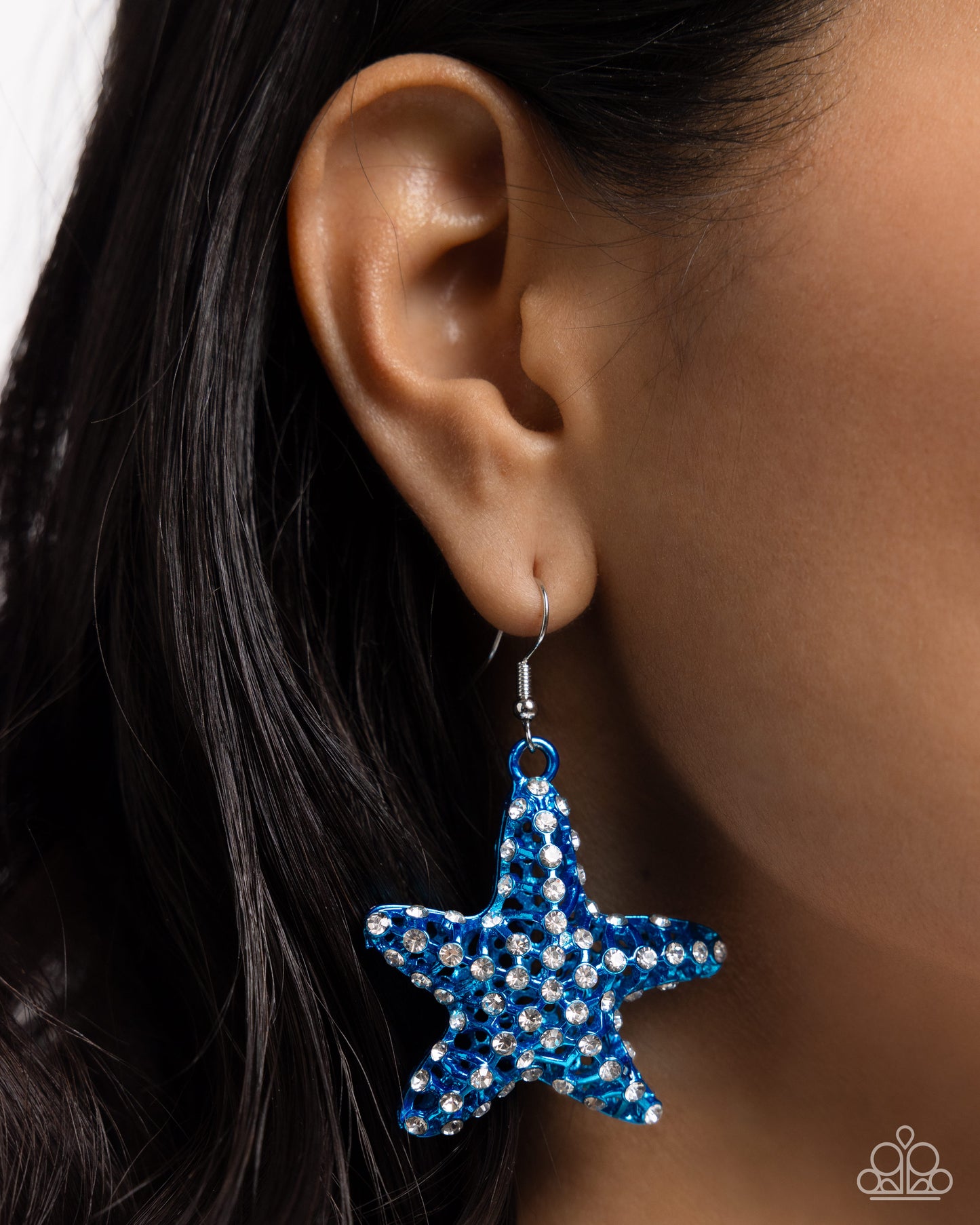 Skilled Starfish Blue Earring - Paparazzi Accessories  Featuring an explosion of dainty white rhinestones, an airy blue starfish charm flickers and flashes below the ear for a seaworthy statement. Earring attaches to a standard fishhook fitting.  Sold as one pair of earrings.  P5ST-BLXX-053XX