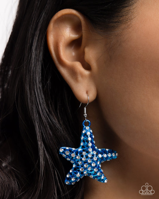 Skilled Starfish Blue Earring - Paparazzi Accessories  Featuring an explosion of dainty white rhinestones, an airy blue starfish charm flickers and flashes below the ear for a seaworthy statement. Earring attaches to a standard fishhook fitting.  Sold as one pair of earrings.  P5ST-BLXX-053XX