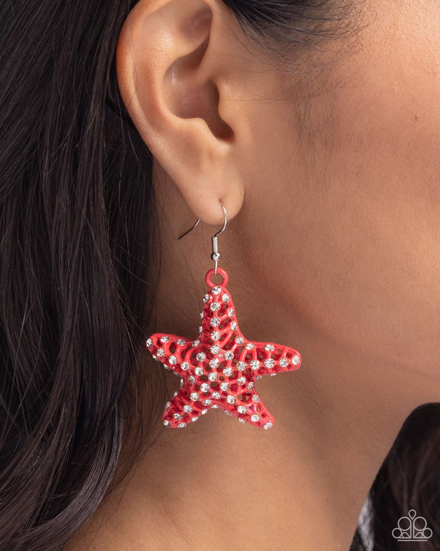 Skilled Starfish Orange Earring - Paparazzi Accessories  Featuring an explosion of dainty white rhinestones, an airy orange starfish charm flickers and flashes below the ear for a seaworthy statement. Earring attaches to a standard fishhook fitting.  Sold as one pair of earrings.  P5ST-OGXX-032XX