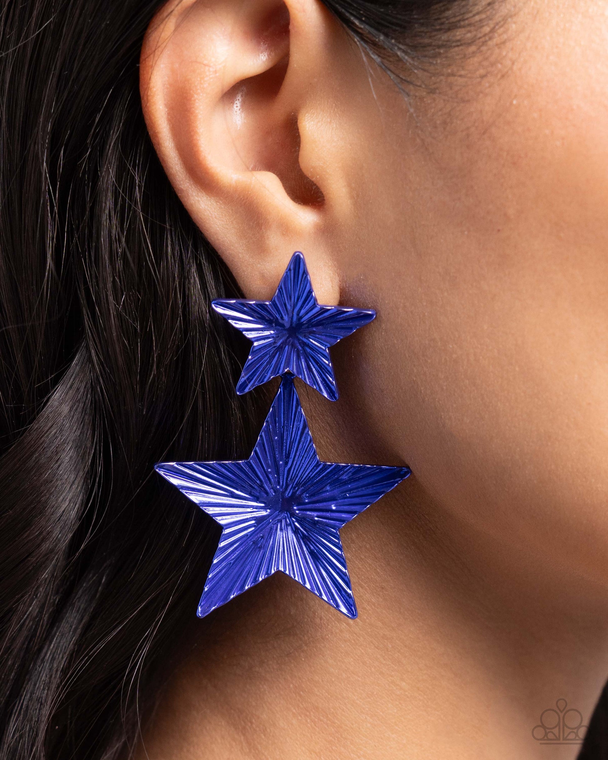 Patriotic Promise Blue Star Post Earring - Paparazzi Accessories  Delicately fluted in shimmery textures, vibrant blue stars, one larger than the other, delicately link into a stacked, patriotic lure. Earring attaches to a standard post fitting.  Sold as one pair of post earrings.  P5PO-BLXX-187XX