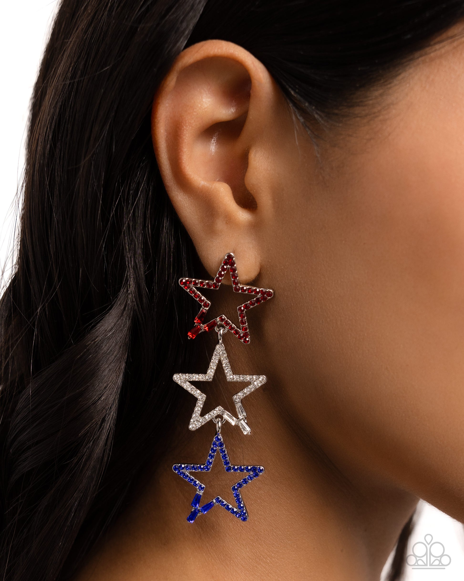 Patriotic Pageantry Multi Star Post Earring - Paparazzi Accessories  Embellished in red, white, and blue rhinestones and emerald-cut gems, a trio of airy silver stars interlock and cascade below the ear for a polished, patriotic look. Earring attaches to a standard post fitting.  Sold as one pair of post earrings.  P5PO-MTXX-133XX