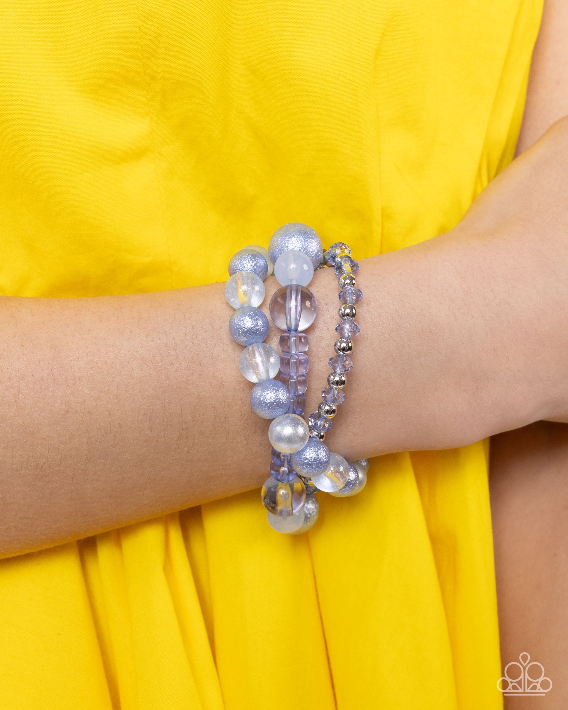 Shattered Stack Blue Stretch Bracelet - Paparazzi Accessories  Chambray Blue milky, clear, and glittery beads in varying sizes and faceted details combine with sleek silver beads along elastic stretchy bands for a colorful stack.  Sold as one set of three bracelets.  P9WH-BLXX-289ZE