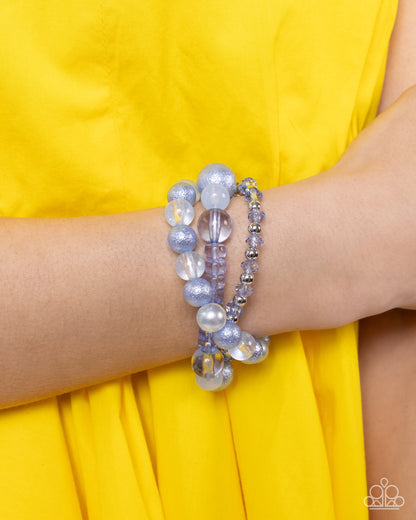 Shattered Stack Blue Stretch Bracelet - Paparazzi Accessories  Chambray Blue milky, clear, and glittery beads in varying sizes and faceted details combine with sleek silver beads along elastic stretchy bands for a colorful stack.  Sold as one set of three bracelets.  P9WH-BLXX-289ZE