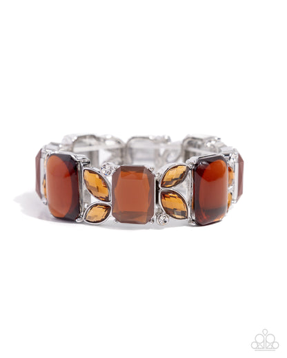 Lavish Laurels Brown Stretch Bracelet - Paparazzi Accessories  Transparent brown emerald-cut acrylics and topaz emerald-cut gems alternate with a duo of tea marquise-cut gems and solitaire white gems along elastic stretchy bands on the wrist for a leisurely lavish look.  Sold as one individual bracelet.  P9RE-BNXX-196XX