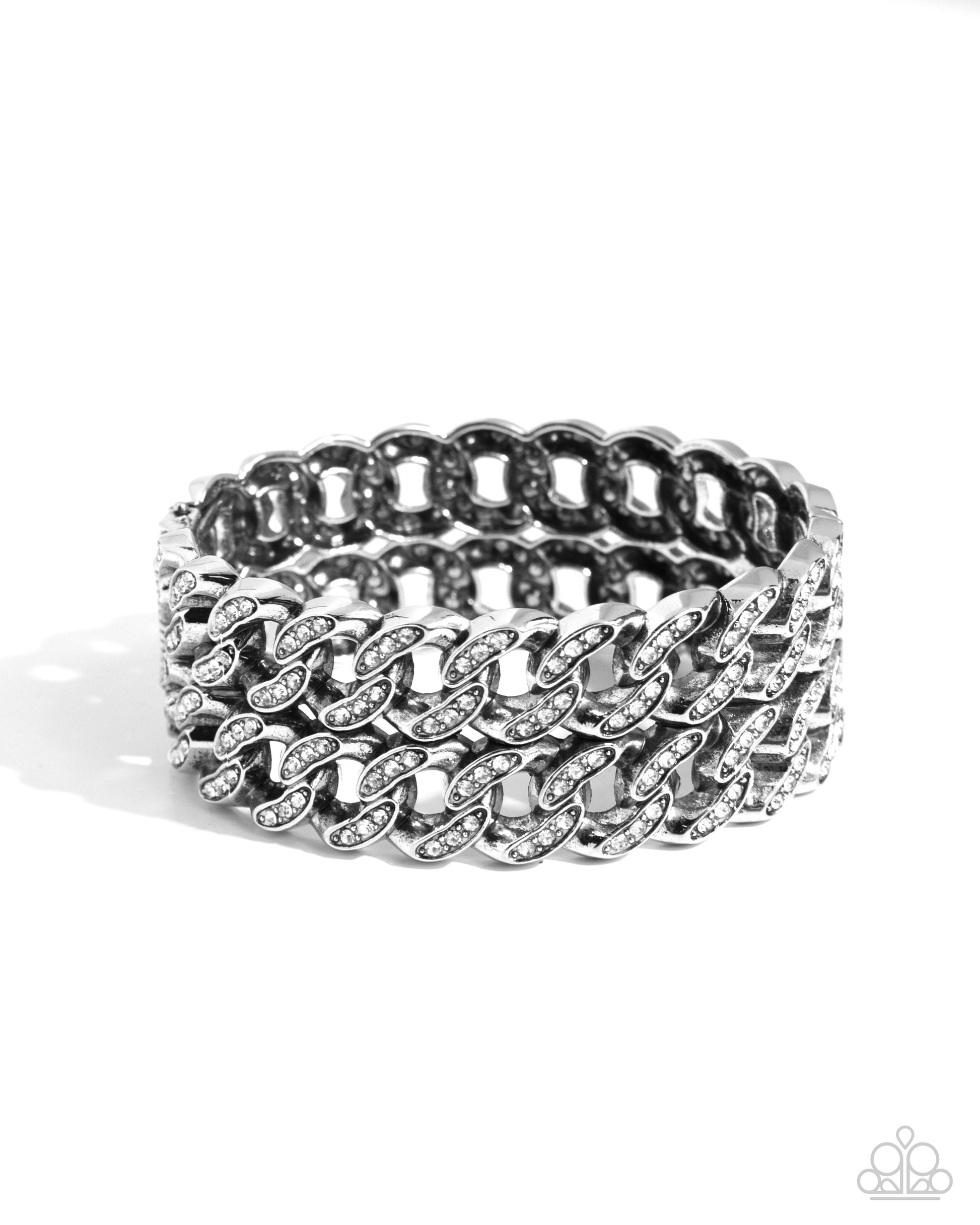 Braided Bandit White Stretch Bracelet - Paparazzi Accessories  Embellished with glistening white rhinestones, elongated silver curb chains stack atop one another to create a bold, stackable braided look along the wrist.  Sold as one individual bracelet.  P9ED-WTXX-060XX