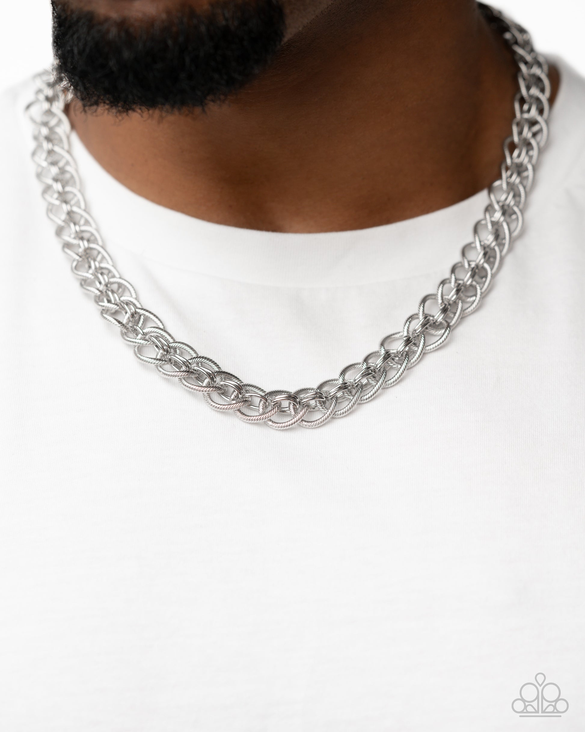 Coiled Conviction Silver Unisex Necklace - Paparazzi Accessories  A collection of coiled silver rings interlock between duos of sleek, high-sheen silver rings along the neckline for a confidently chic look. Features an adjustable clasp closure.  Sold as one individual necklace.  P2MN-URSV-078XX