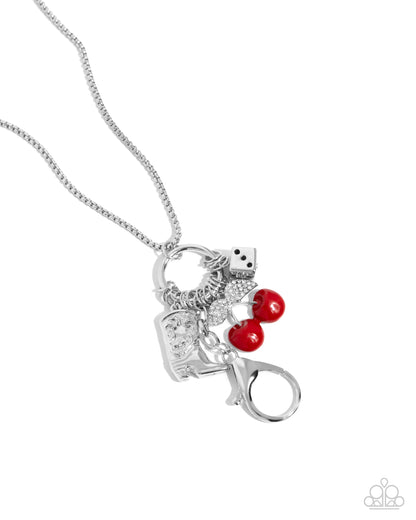 Casual Cowboy Red Lanyard - Paparazzi Accessories  Dancing along a round box silver chain, a collection of white rhinestone-embellished red cherries, a black-painted die, and a detailed silver-heeled cowboy boot connect to a silver ring below the neckline for a chic Western look. A lobster clasp hangs from the bottom of the design to allow a name badge or other item to be attached. Features an adjustable clasp closure.  Sold as one individual lanyard. Includes one pair of matching earrings.  P2LN-RDXX-017XX