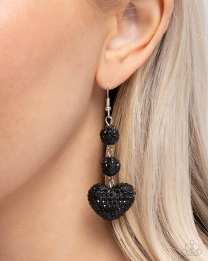 Vision in Shimmer Black Heart Earring - Paparazzi Accessories  Embellished in defaced jet black rhinestones, a duo of black ornaments and a black heart delicately link into an elegant lure, creating a shimmery look. Earring attaches to a standard fishhook fitting.  Sold as one pair of earrings.  P5RE-BKXX-466XX