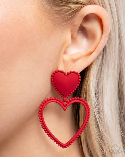 Casual Chemistry Red Heart Post Earring - Paparazzi Accessories  Embellished in red-painted studs, an acrylic red heart gives way to an oversized red heart silhouette for a sophisticatedly sweet look. Earring attaches to a standard post fitting.  Sold as one pair of post earrings.  P5PO-RDXX-070XX