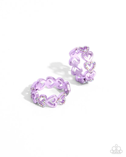 Historic Hearts Purple Hinge Hoop Earring - Paparazzi Accessories  Featuring a metallic purple dip, glittery iridescent rhinestone-embellished hearts alternate with sleek hearts as they curve along the ear for a romantic statement. Earring attaches to a standard hinge closure fitting. Hoop measures approximately 1" in diameter. Due to its prismatic palette, color may vary.  Sold as one pair of hinge hoop earrings.  P5HO-PRXX-033XX