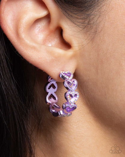 Historic Hearts Purple Hinge Hoop Earring - Paparazzi Accessories  Featuring a metallic purple dip, glittery iridescent rhinestone-embellished hearts alternate with sleek hearts as they curve along the ear for a romantic statement. Earring attaches to a standard hinge closure fitting. Hoop measures approximately 1" in diameter. Due to its prismatic palette, color may vary.  Sold as one pair of hinge hoop earrings.  P5HO-PRXX-033XX