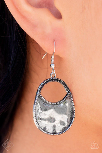 Earring: "Rio Rancho Relic" (P5SE-SVXX-156EF)- A daintily dotted wide oval silver frame is partially filled with a high sheen hammered silver, leaving an airy cutout at the top for a polished finish. Earring attaches to a standard fishhook fitting.  Sold as one pair of earrings.