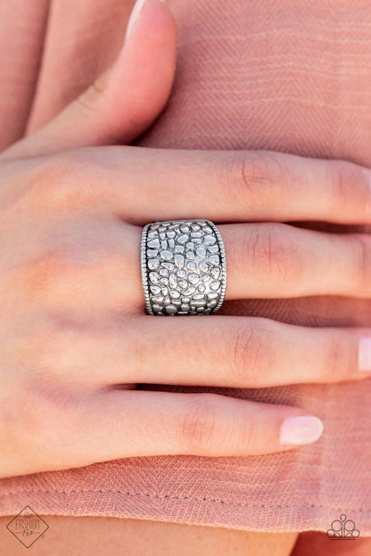 Ring: "Dotted Decorum" (P4BA-SVXX-051EF)- Brimming from edge to edge with a studded texture reminiscent of cobblestone, a wide silver band is bordered in dainty studs resulting in a free-spirited fashion atop the finger. Features a stretchy band for a flexible fit.  Sold as one individual ring.