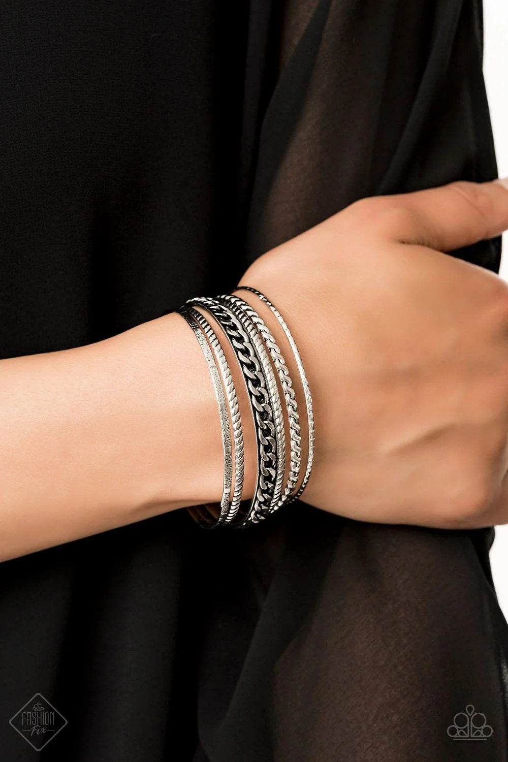 Bracelet: "Mayan Mix" (P9IN-SVXX-151MS)  Featuring an array of chain-like and tribal inspired patterns, a collection of mismatched silver bangles slides up and down the wrist for an edgy look.&nbsp;