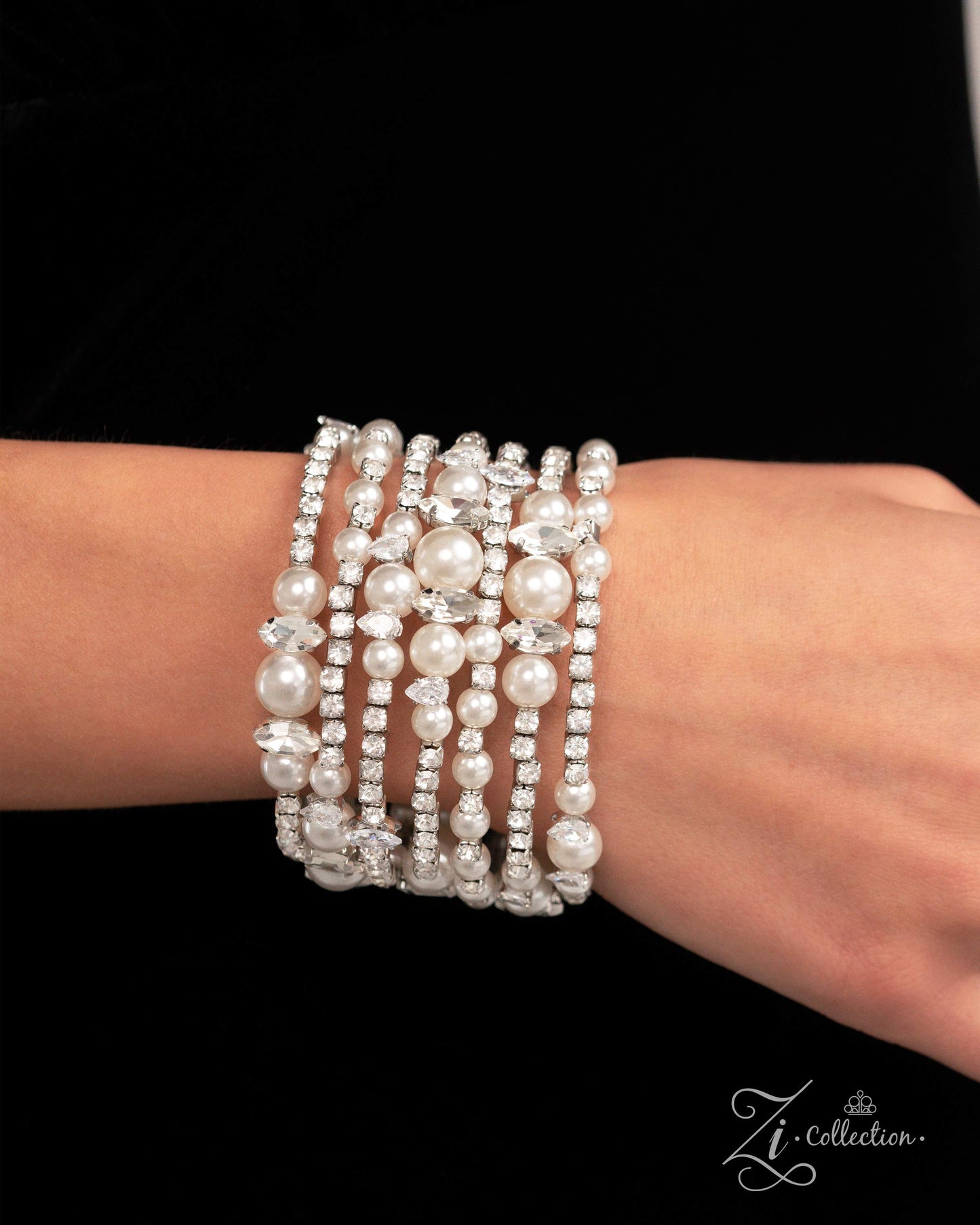 Sentimental Value White Pearl Coil Infinity Wrap Zi Bracelet - Paparazzi Accessories  Item #Z2422   Featuring various dazzling dimensions, a collection of glossy white pearls, elevated-pronged white teardrop and marquise-cut gems, and sparkling white gems in squared silver fittings is threaded along an invisible wire that coils around the wrist. Each flick of the wrist captures a different detail, showcasing the infinity wrap’s irresistible shimmer and range of refinement.  Sold as one individual bracelet.