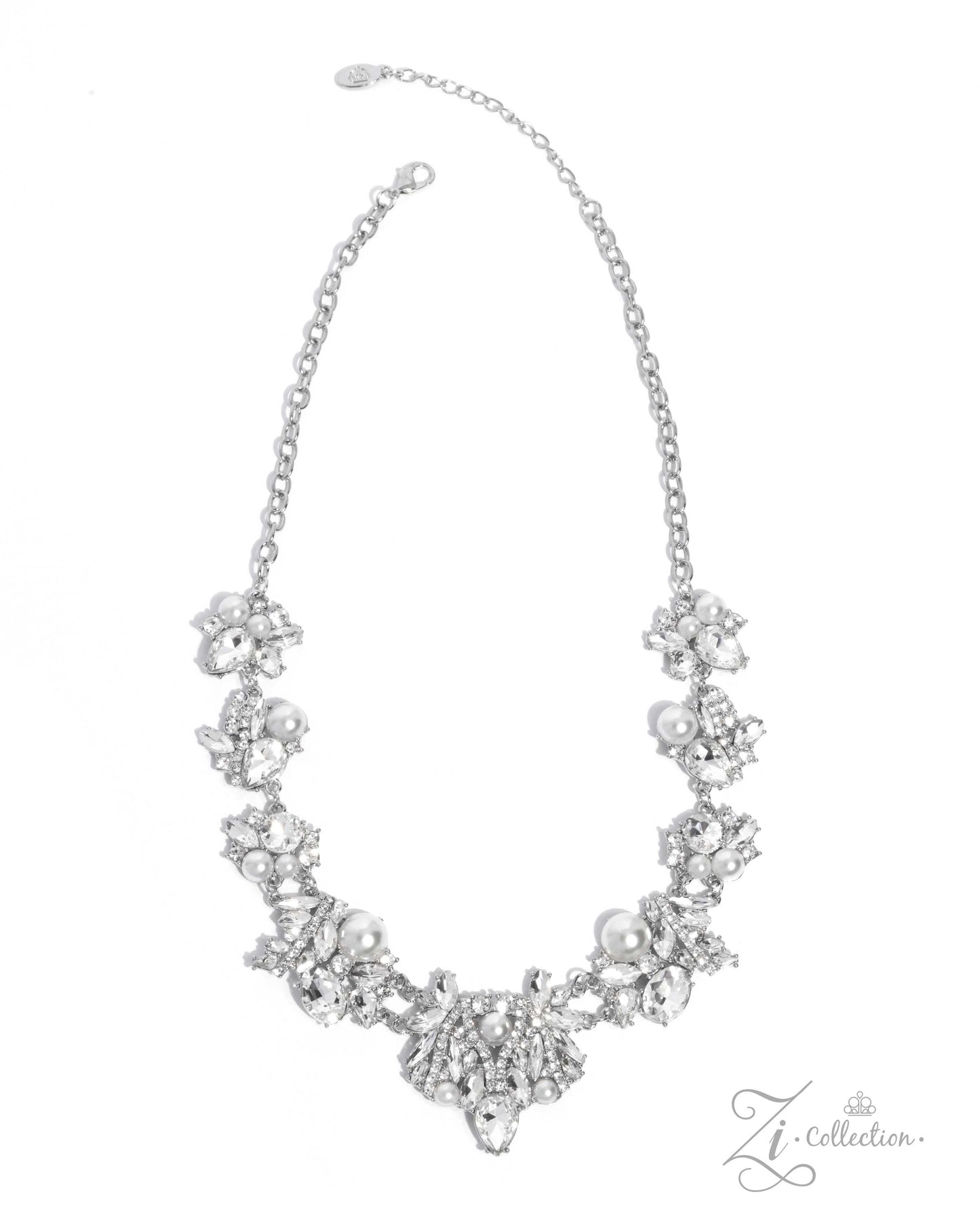 The Aleshia White Pearl 2024 Zi Necklace - Paparazzi Accessories  Item #Z2410   Clusters of marquise-cut and teardrop gems, round white rhinestones, white pearls, and pieces of rhinestone-encrusted silver bars link together along the collar, creating an explosion of extravagant sparkle. The dramatic angles of the silver bars exaggerate the dramatic crystal-like radiance of each pronged gem, adding further dimension to the design. The size and intensity of the radically refined clusters slowly increase as th