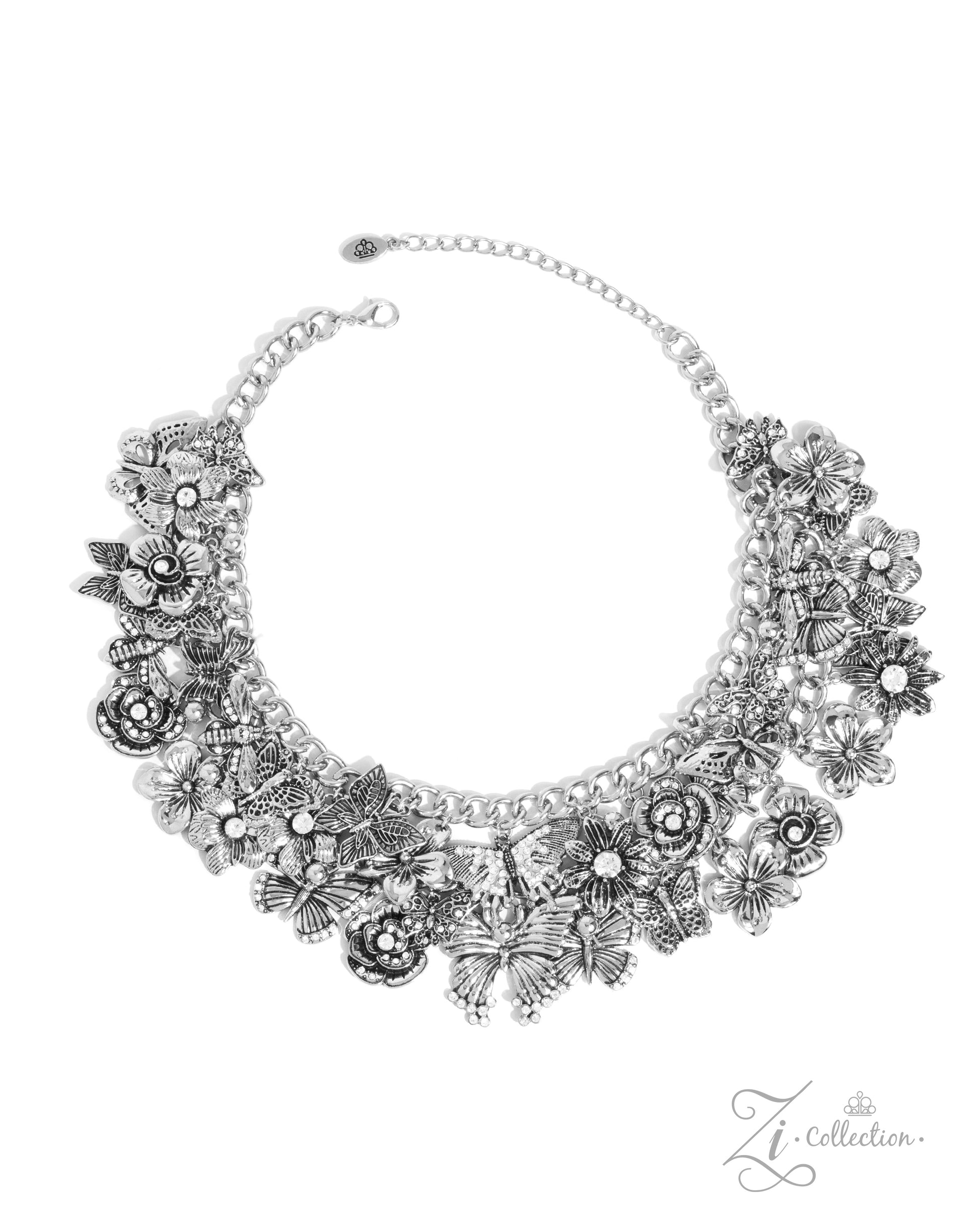 The McKayla Silver Butterfly 2024 Zi Necklace - Paparazzi Accessories  Item #Z2407   A whimsical collection of shimmery luminescent and intricately detailed silver charms — including rhinestone-embellished flowers and airy butterflies — dance from a chunky silver chain that adorns the collar in two layers, creating a boisterous, blissful fringe. Features an adjustable clasp closure.  Sold as one individual necklace. Includes one pair of matching earrings.  Named after the 2024 Seize the Spotlight winner, Mc