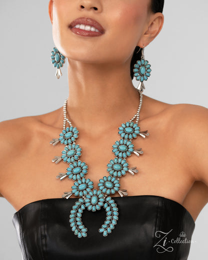 The Shelby Turquoise 2024 Zi Necklace - Paparazzi Accessories  Item #Z2409  A collection of turquoise stone-embellished squash blossom frames, with an oversized crescent-shaped pendant at its center, cascades below the neckline from a strand of silver beads that split into two distinct strands. The vibrant splashes of color and antiqued rope-textured centers of the squash blossom frames infuse the rustic design with a hint of surprising whimsicality and traditional timelessness. Features an adjustable clasp