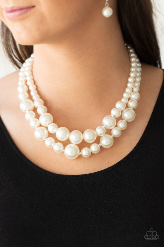 The More The Modest White Pearl Necklace - Paparazzi Accessories  Infused with dainty silver accents, classic white pearls layer below the collar in a timeless fashion. Features an adjustable clasp closure.  All Paparazzi Accessories are lead free and nickel free!   Sold as one individual necklace. Includes one pair of matching earrings.