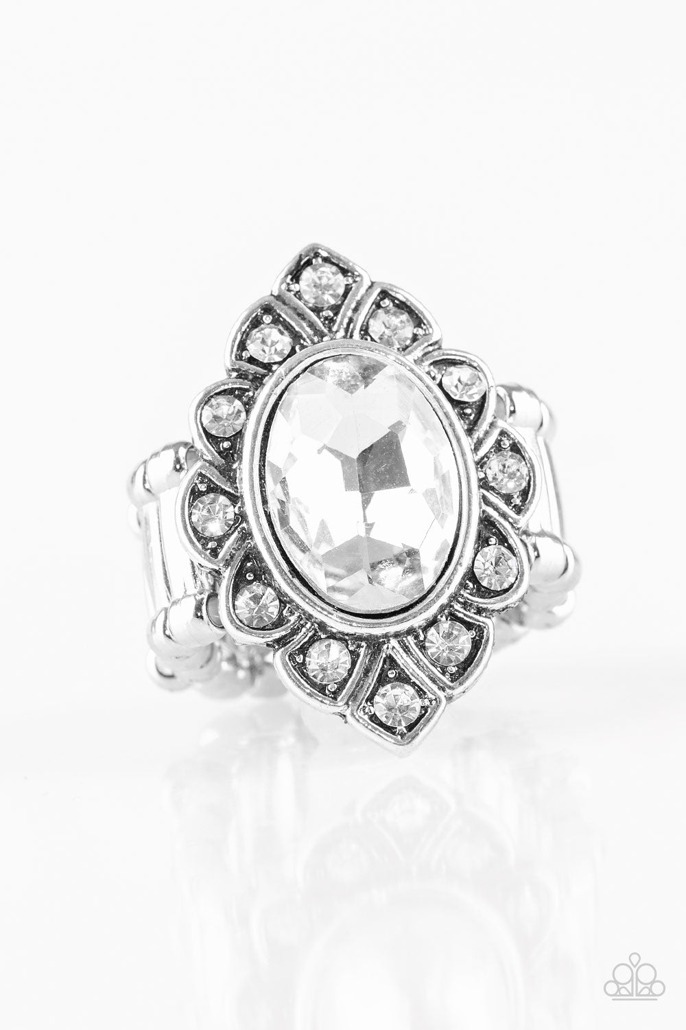 Power Behind The Throne White Ring - Paparazzi Accessories  A faceted white gem is pressed into a marquise-shaped silver frame radiating with glittery white rhinestones for a regal look. Features a stretchy band for a flexible fit.  Sold as one individual ring.