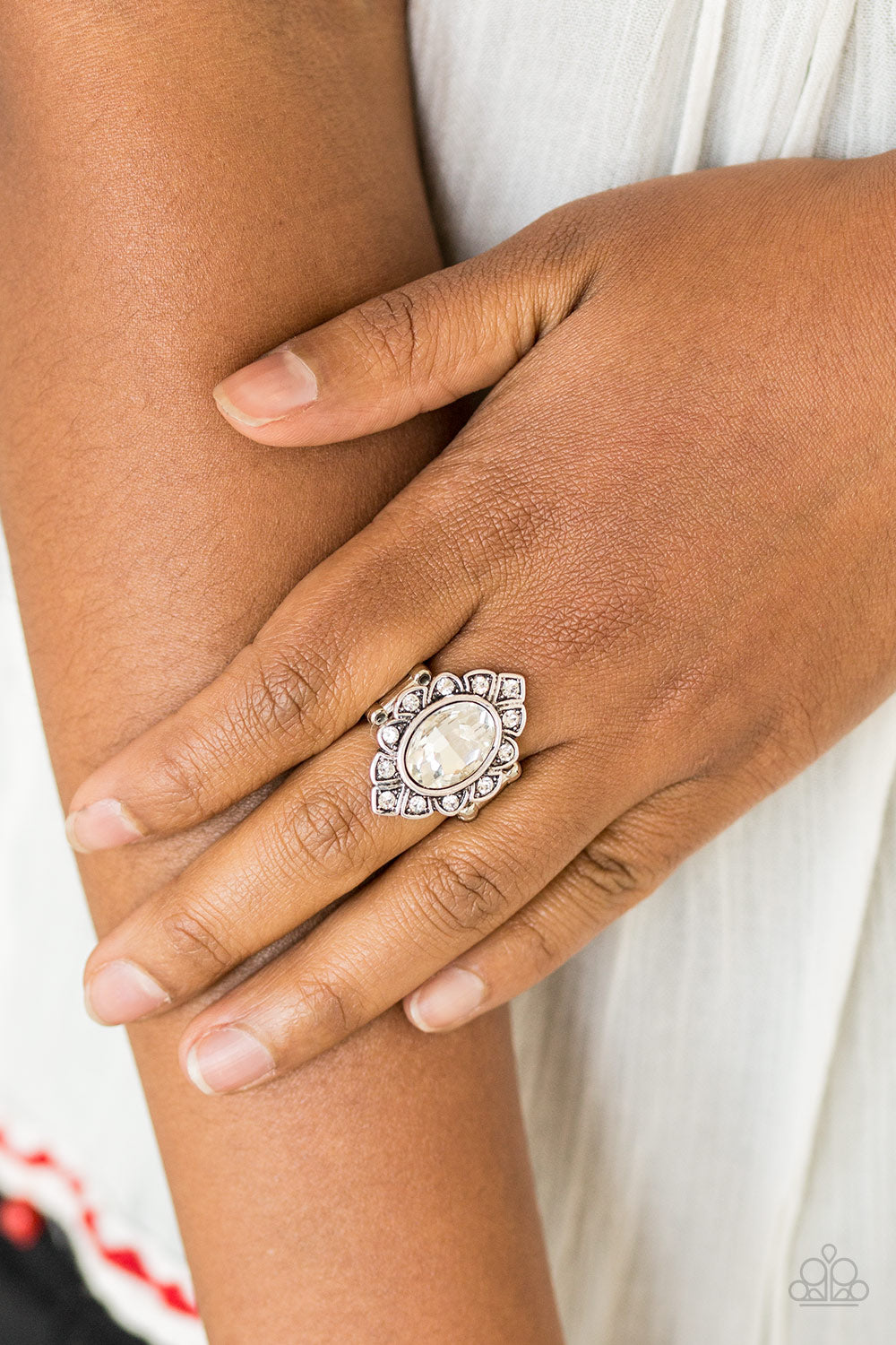 Power Behind The Throne White Ring - Paparazzi Accessories  A faceted white gem is pressed into a marquise-shaped silver frame radiating with glittery white rhinestones for a regal look. Features a stretchy band for a flexible fit.  Sold as one individual ring.