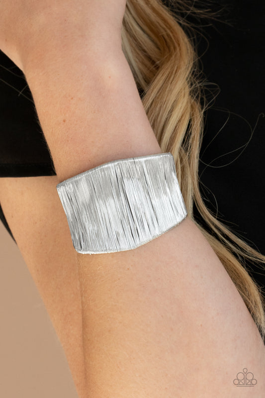 Hot Wired Wonder Silver Cuff Bracelet - Paparazzi Accessories. ​A seemingly infinite collection of shimmery silver wire wraps around a substantial silver cuff, creating a bold industrial inspired centerpiece around the wrist.  All Paparazzi Accessories are lead free and nickel free!  Sold as one individual bracelet.