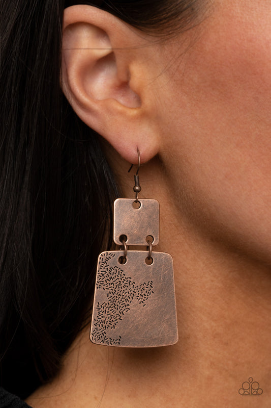 Tagging Along Copper Earring - Paparazzi Accessories.  Stamped in an abstract pattern, a flared copper plate links to the bottom of a square copper frame, creating a rustic lure. Earring attaches to a standard fishhook fitting.  ﻿All Paparazzi Accessories are lead free and nickel free!  Sold as one pair of earrings.