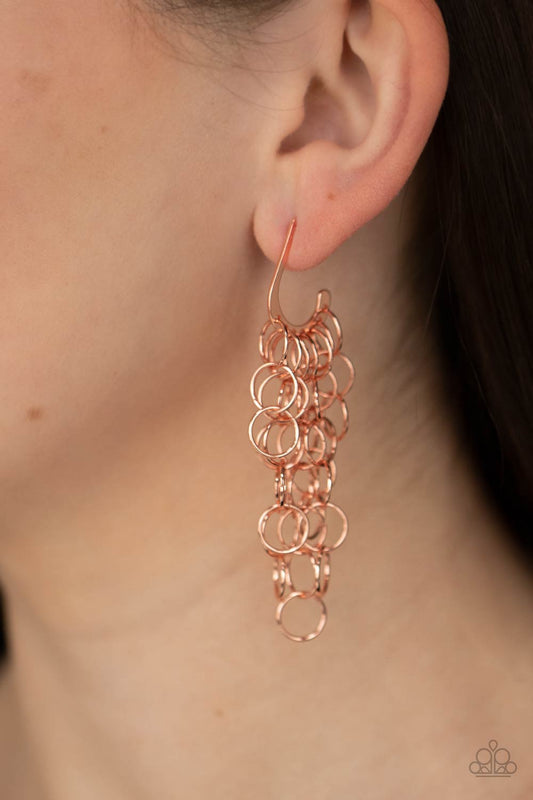 ong Live The Rebels Copper Earring - Paparazzi Accessories  Strands of shiny copper links cascade from the bottom of a dainty hook shaped hoop, creating a rebellious fringe. Hoop measures approximately 1/2" in diameter. Earring attaches to a standard post fitting.  ﻿All Paparazzi Accessories are lead free and nickel free!  Sold as one pair of hoop earrings.