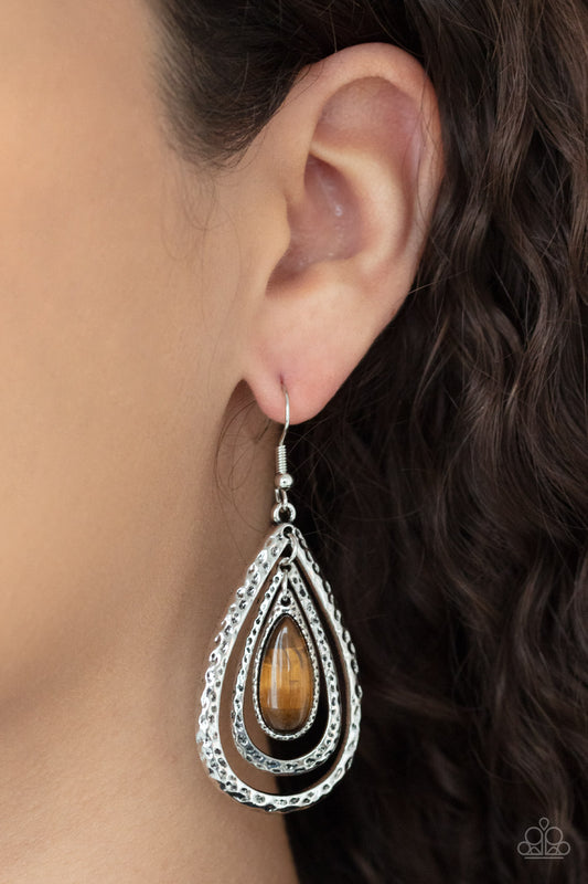 Teardrop Torrent Brown Earring - Paparazzi Accessories  A teardrop tiger's eye stone swings from the top of a hammered silver frame that links to a larger hammered silver frame, creating a rippling lure. Earring attaches to a standard fishhook fitting.  ﻿All Paparazzi Accessories are lead free and nickel free!  Sold as one pair of earrings.