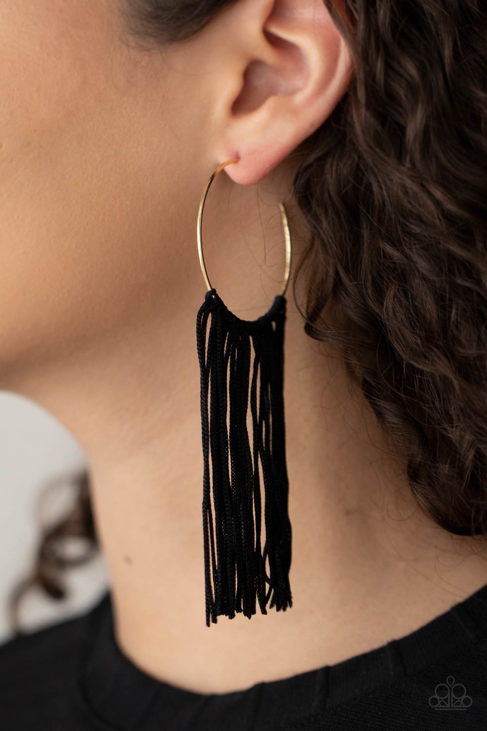 Flauntable Fringe Gold Hoop Earring - Paparazzi Accessories  A curtain of black cords stream from the center of a dainty gold hoop, creating a glamorous fringe. Earring attaches to a standard post fitting. Hoop measures approximately 1 3/4" in diameter.  All Paparazzi Accessories are lead free and nickel free!  Sold as one pair of hoop earrings.