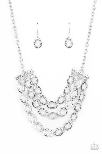 Repeat After Me Silver Necklace - Paparazzi Accessories  Three rows of shiny silver chains with oversized hammered oval links attach to silver bars for an edgy display below the collar. Features an adjustable clasp closure.  All Paparazzi Accessories are lead free and nickel free!   Sold as one individual necklace. Includes one pair of matching earrings.