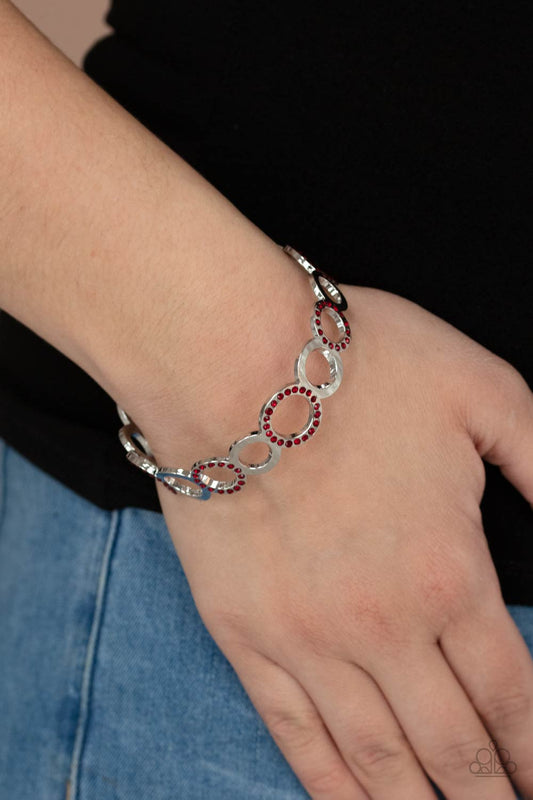 Future, Past, and POLISHED Red Bangle Bracelet - Paparazzi Accessories  A glittery collection of fiery red rhinestone encrusted rings and shiny silver hoops coalesce into an airy bangle around the wrist.  Sold as one individual bracelet.