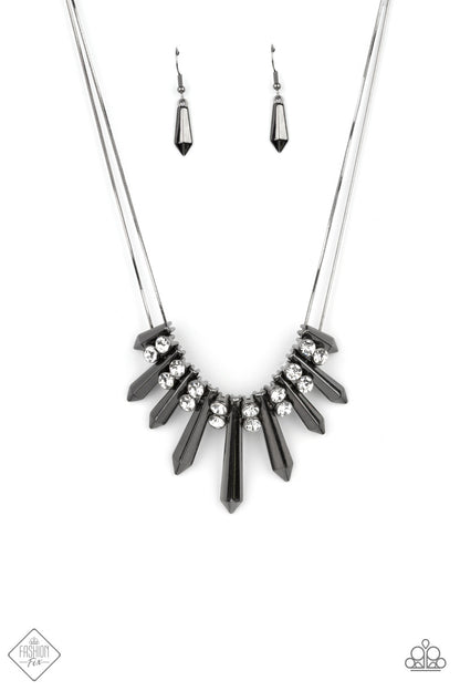 Dangerous Dazzle Black Necklace - Paparazzi Accessories  Pairs of glittery white rhinestones alternate between flared gunmetal rods that are threaded along two rows of flat gunmetal chains, creating a dangerously dazzling fringe below the collar. Features an adjustable clasp closure.  All Paparazzi Accessories are lead free and nickel free!  Sold as one individual necklace. Includes one pair of matching earrings.