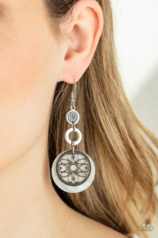 Royal Marina White Earring - Paparazzi Accessories  Reminiscent of an eclipse, an airy silver ring radiating with ornate petals, sways in front of a white shell-like disc. Silver rings in graduating sizes cascade from the top for a whimsically nautical look. Earring attaches to a standard fishhook fitting.  ﻿All Paparazzi Accessories are lead free and nickel free!  Sold as one pair of earrings.