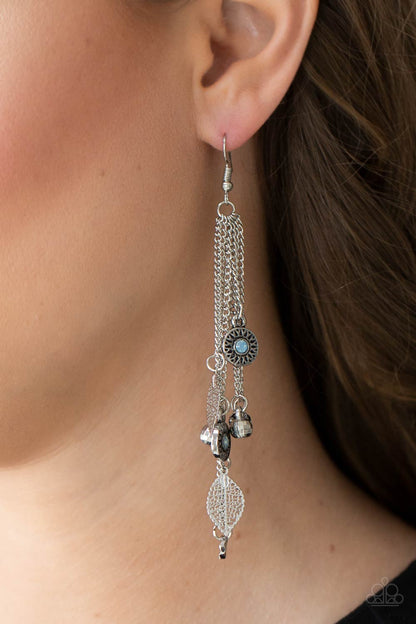 A Natural Charmer Blue Earring - Paparazzi Accessories. Dewy Cerulean rhinestone dotted frames, airy silver leaves, silver disco ball-like beads stream from the bottoms of dainty silver chains, creating a whimsically tasseled display. Earring attaches to a standard fishhook fitting.  All Paparazzi Accessories are lead free and nickel free!  Sold as one pair of earrings.