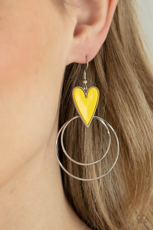 Happily Ever Hearts Yellow Earring - Paparazzi Accessories  Dainty silver hoops attach to the bottom of a playful Illuminating heart frame, creating a flirtatious pop of color. Earring attaches to a standard fishhook fitting.  All Paparazzi Accessories are lead free and nickel free!  Sold as one pair of earrings.