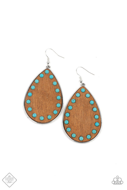 Rustic Refuge Blue Earring - Paparazzi Accessories.  Dainty turquoise stone beads border an earthy wooden teardrop frame that is encased in a sleek silver fitting, creating a whimsical woodsy lure. Earring attaches to a standard fishhook fitting.  ﻿All Paparazzi Accessories are lead free and nickel free!  Sold as one pair of earrings.