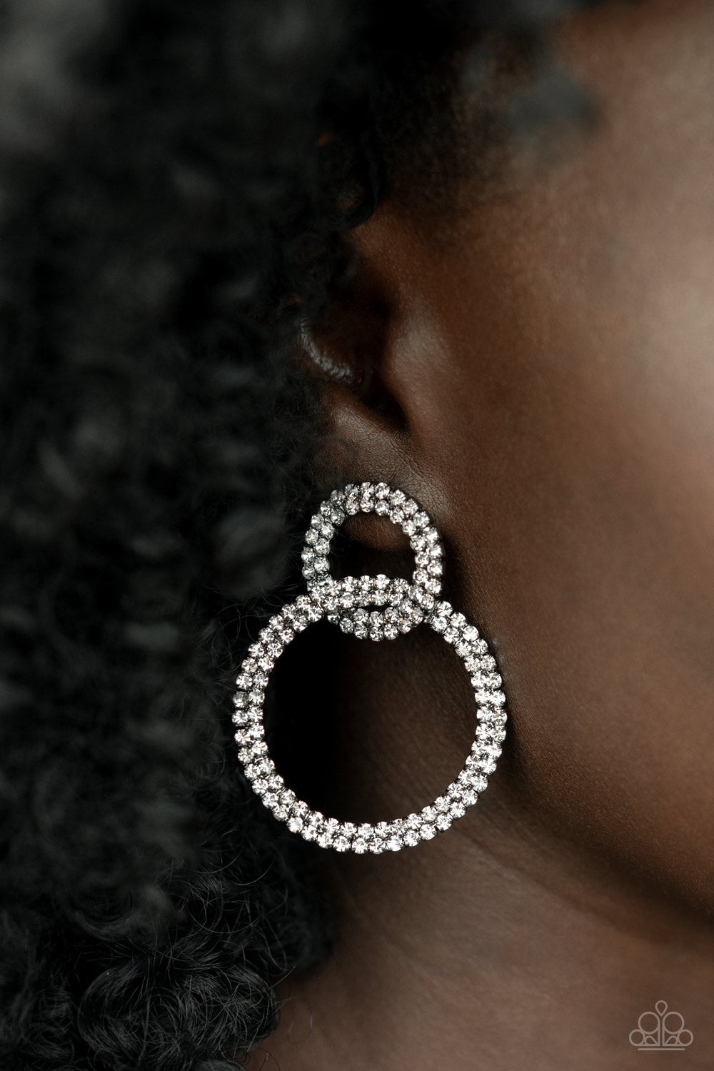 Intensely Icy Black Post Earring - Paparazzi Accessories  Rows of sparkly white rhinestones encircle into two interconnected hoops, creating a jaw-dropping lure. Earring attaches to a standard post fitting.  Sold as one pair of post earrings.