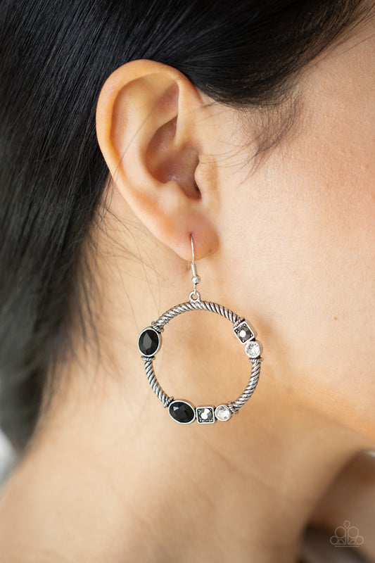 Glamorous Garland Multi Earring - Paparazzi Accessories. A glittery collection of black oval, square hematite, and classic white rhinestones haphazardly adorn the front of a textured silver hoop, for a gritty-glamorous look. Earring attaches to standard fishhook fittings.  All Paparazzi Accessories are lead free and nickel free!  Sold as one pair of earrings.