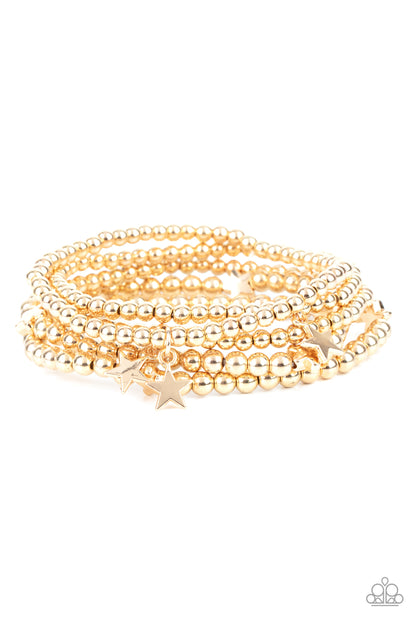 American All-Star Gold Bracelet - Paparazzi Accessories  Infused with dainty gold star beads and shiny gold star charms, strands of gold beaded stretchy bands stack across the wrist, creating a patriotic shimmer.  All Paparazzi Accessories are lead free and nickel free!  Sold as one set of five bracelets.