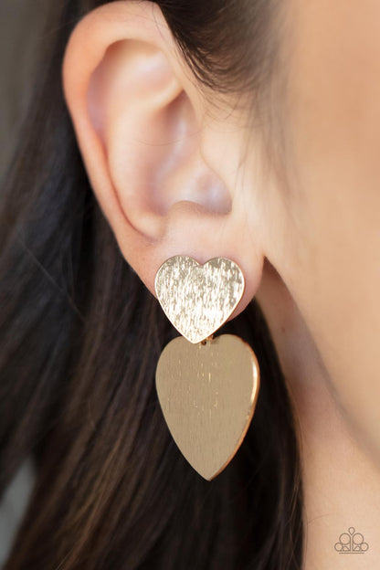 Heart-Racing Refinement - Gold Item #P5PO-GDXX-175XX Delicately scratched in shimmer, a dainty gold heart frame delicately links with a larger gold heart frame for a flirtatiously layered look. Earring attaches to a standard post earring.  Sold as one pair of post earrings.