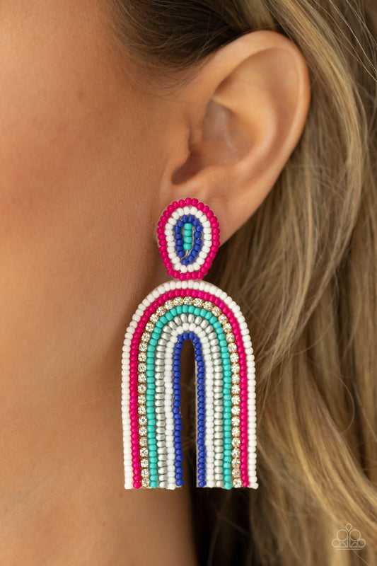 Rainbow Remedy Multi Seed Bead Earring - Paparazzi Accessories  Infused with a single row of glassy white rhinestones, dainty strands of white, pink, turquoise, silver, and blue seed beads stack into a colorful rainbow at the bottom of a matching seed beaded fitting. Earring attaches to a standard post fitting.  Sold as one pair of post earrings.