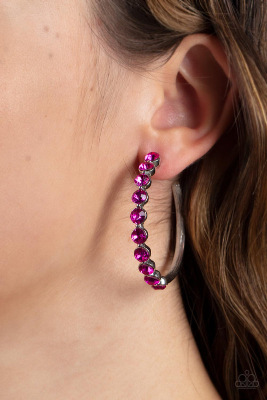 Photo Finish Pink Hoop Earring - Paparazzi Accessories  The front of a bold silver hoop is encrusted in flamboyant Fuchsia Fedora rhinestones, creating a glamorous pop of sparkle. Earring attaches to a standard post fitting. Hoop measures approximately 1 3/4" in diameter.  Sold as one pair of hoop earrings.